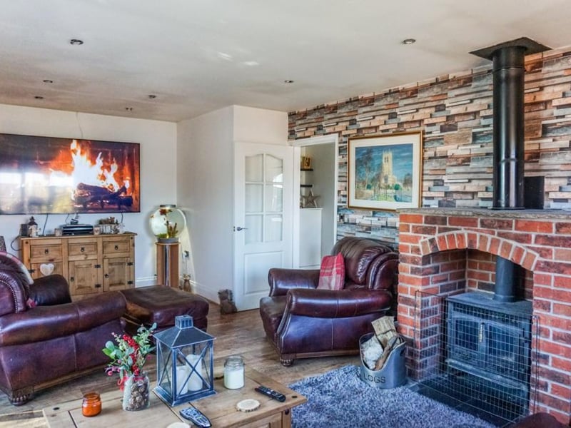 Spacious living room with feature multi fuel log burner.
