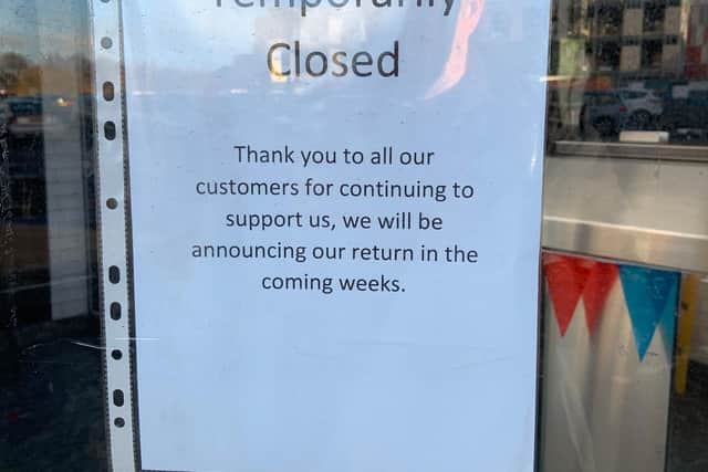The temporary closure sign in the door of the Spire Frier chippy in Chesterfield.