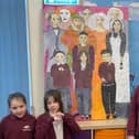 Pupils from Dunston Academy with their impressive artwork featuring Derbyshire heroes.
