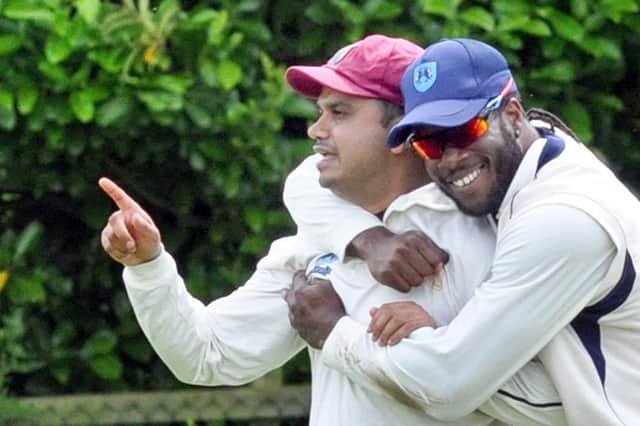 Kamran Afzaal, left, is congratulated after taking a wicket for Retford.