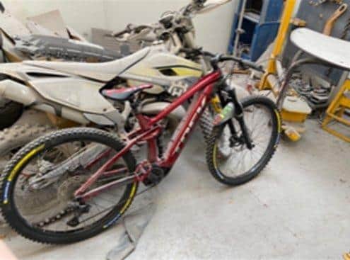 The Bike is an E-bike, trek rail 5. The top half is purple or maroon colour  and the bottom half is a gun metal grey. The offender was a male around 6 feet tall, wearing dark coloured jogging bottoms and a dark coloured coat, with the hood up.