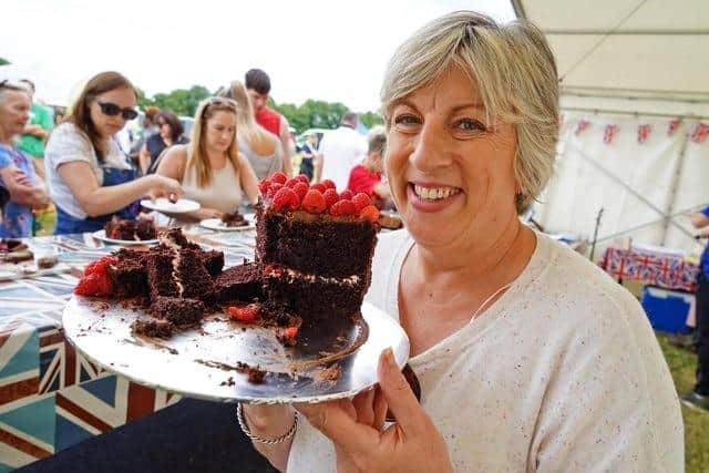 Sandy Docherty hands around the cake at last year's festival.