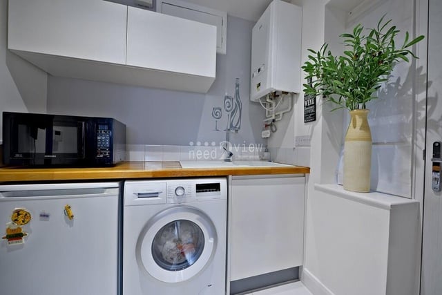 Close to the kitchen and dining area is this useful utility room, which has space and plumbing for a washing machine and a fridge freezer. It is fitted with white wall and base units and a single drainer sink with chrome mixer tap.
