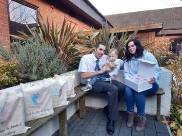 Chloe Colbeck with her partner Roger Nicholson and their son Eli with some of their Byron Memory boxes.
