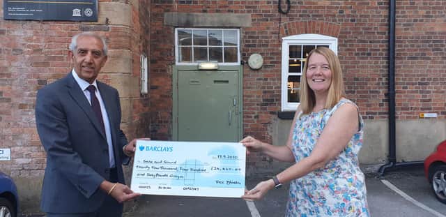 Derbyshire's Police and Crime Commissioner Hardyal Dhindsa presents the cheque for £24,460 to Safe and Sound's chief executive Tracey Harrison.