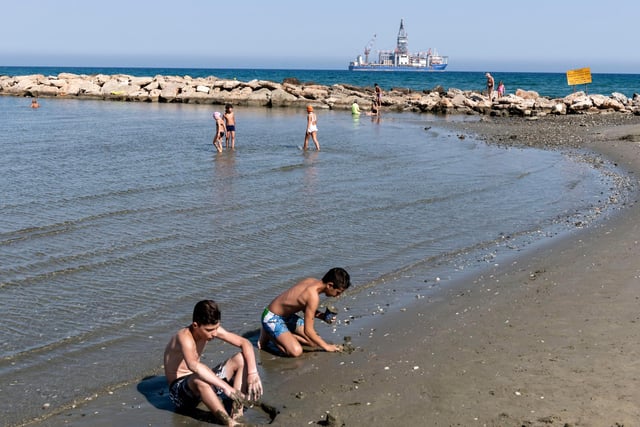 Cypriots cool down at the beach in Larnaca Bay - flights to Larnaca and Paphos go from Doncaster Sheffield Airport.