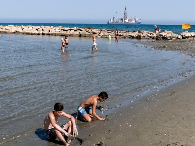 Cypriots cool down at the beach in Larnaca Bay - flights to Larnaca and Paphos go from Doncaster Sheffield Airport.