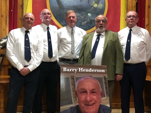 A committee of ex-miners formed for the planning of the statue. Here members pose for a photo with the restored Derbyshire Area NUM banner, alongside a photo of the late Barry Henderson, who brought forth the idea of a commemorative statue to honour the area's fallen miners.