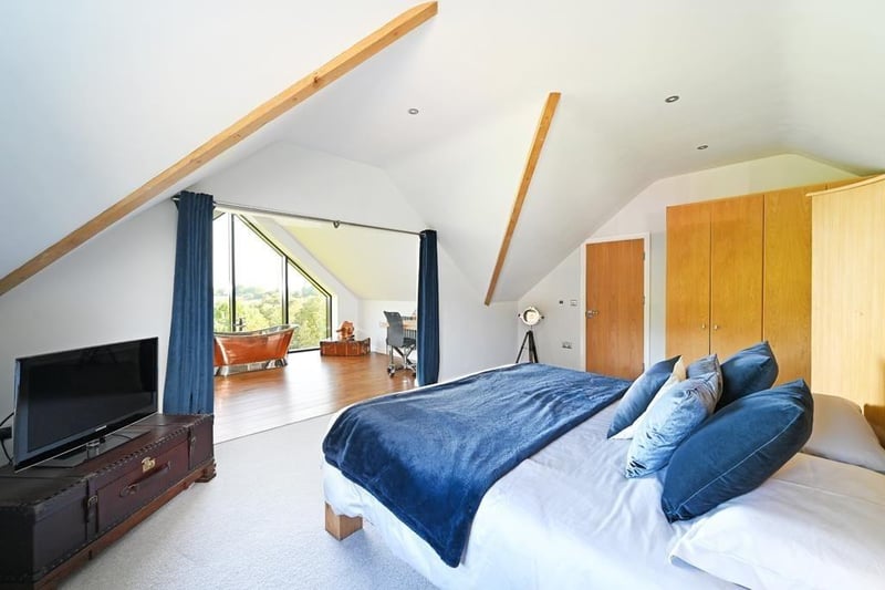 The master bedroom is on the second floor. It features this large bedrooms space and the office/bathroom space through the opening. (Photo courtesy of Zoopla)