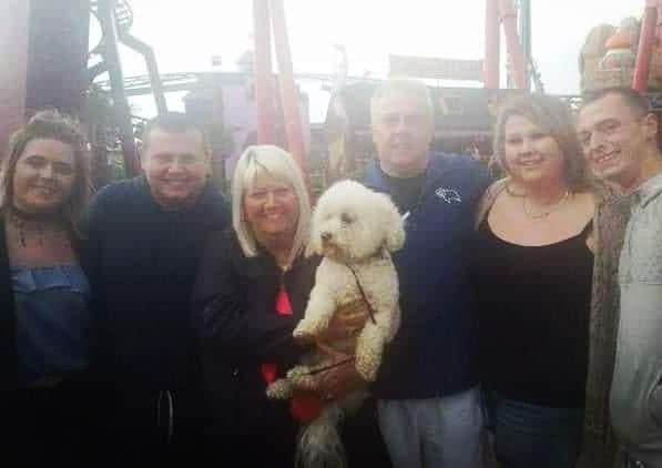 Bichon Frise Marley with Kyle Harvey and Naomi Lomas, right, Maxine and Kevin Lomas to their left and Stefan Lomas with fiance Natasha Hadley