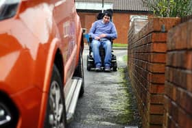 Chesterfield man Aaron Hollingsworth says he regularly struggles to move his powerchair due to cars parked on the pavement. Pictures by Brian Eyre.