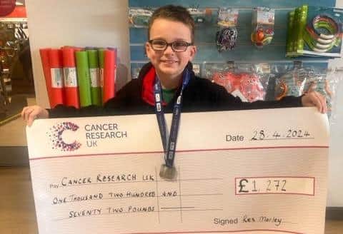 Rex Morley with a cheque for Cancer Research UK