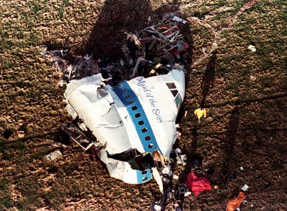 The nose section of Pan Am Flight 103, a 747 airliner  lies in a field outside the village of Lockerbie, Scotland, in this Dec. 22, 1988 file photo.