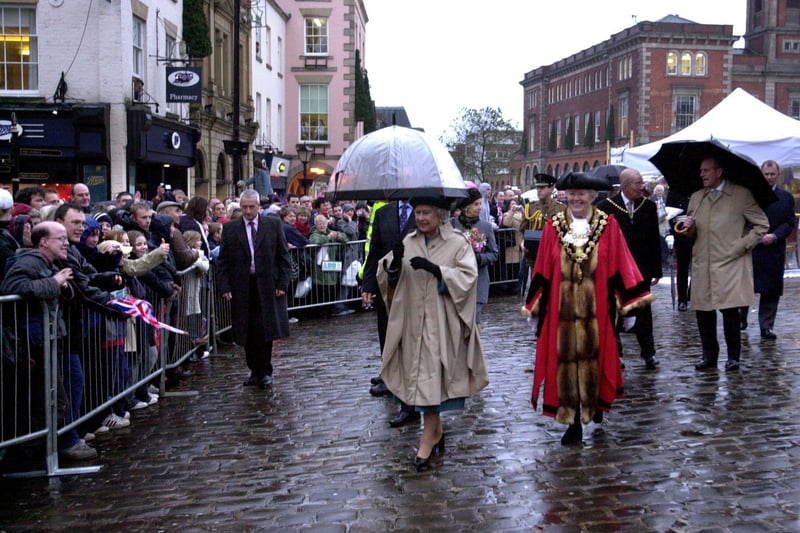 The Queen and the Duke of Edinburgh tour Chesterfield's weekly market meeting stall holders and visitors in 2003.
