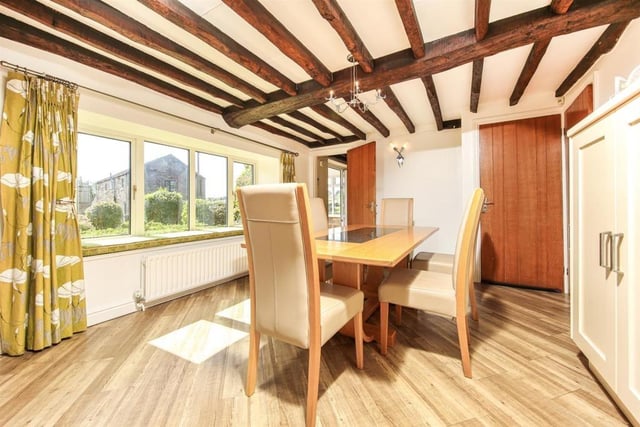 The dining space is an extension of the oak-beamed kitchen, with the two areas separated by a breakfast bar.