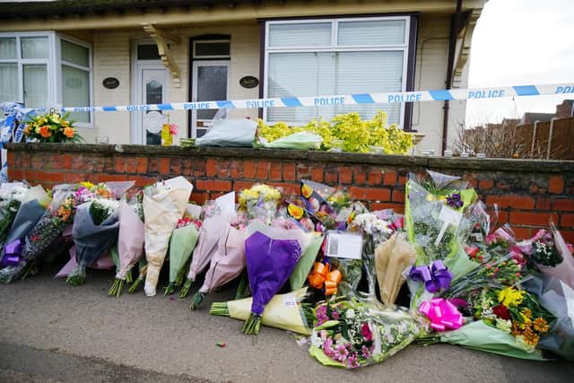Floral tributes have been left outside the Langwith Junction house of Freda and Ken Walker. Pictures by Brian Eyre.