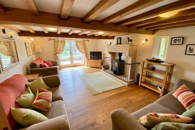 A wood-burning stove sitting in a handsome stone fireplace provides a focal point. There is underfloor heating throughout the ground floor of the house.