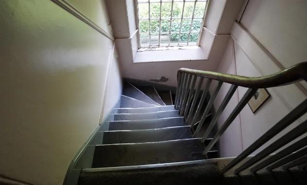 A staircase which turns halfway leads up to the first-floor office accommodation.