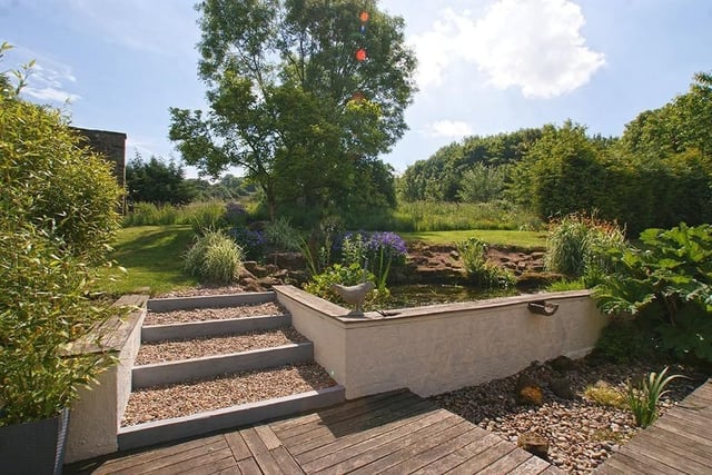 Climb from the decked area to the lawn which is interspersed with ornamental shrubs and mature trees, and an ornamental pond. Beyond the lawn is an area of wildlife garden where there is outline planning consent for the construction of a detached three-bedroom separate dwelling