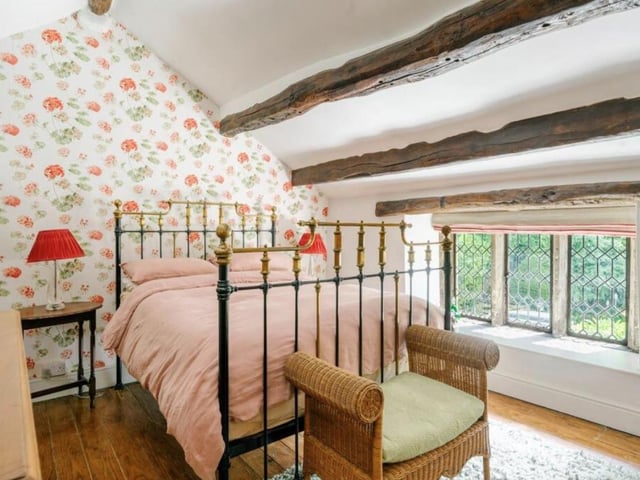Imagine waking up in this pretty bedroom and looking at the gorgeous view through the mullioned window.