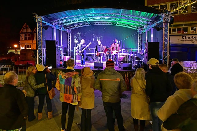 Crowds gather to listen to live music from Origin in the market place