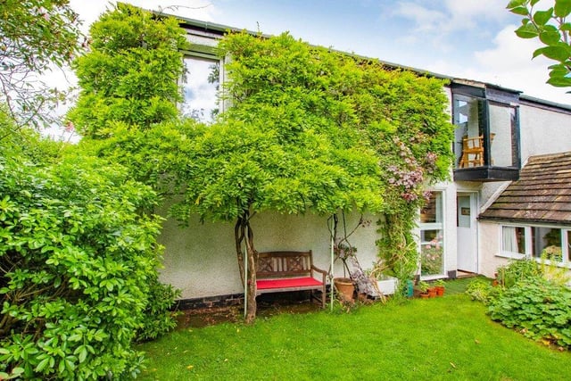The home has a private garden with a lawn, a covered seating area and a vegetable plot.