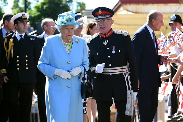 The Queen walks with Lord Lieutenant of Derbyshire, William Tucker, as the Duke of Edinburgh meets schoolchildren outside Matlock station.