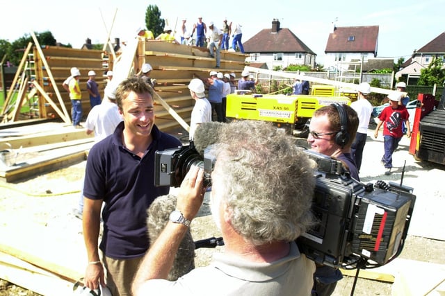 Pictured at the Rammed Earth Site, Manor Drive, in Brimington, where the BBC UK Style were filming Home Wasn't Built in a Day in 2003. Seen is presenter Tris Payne being filmed for the show, with work going on in the background.