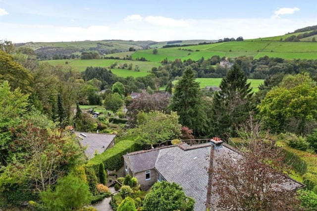 Drone footage shows the bungalow in the foreground with Froggatt hills in the background.