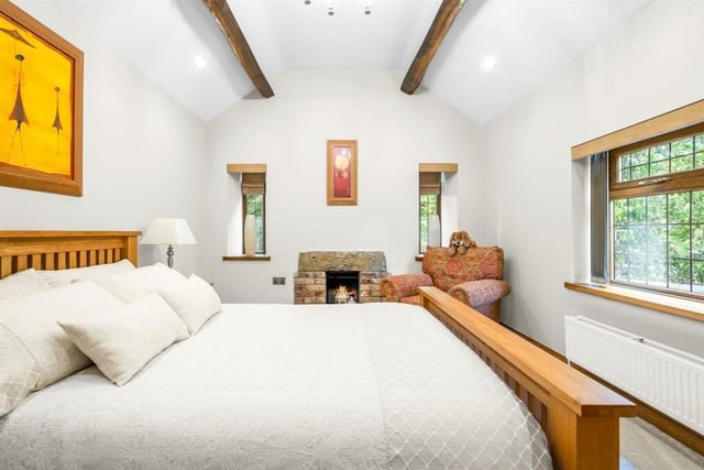 Each bedroom has its own style, this one retains a stone fireplace.