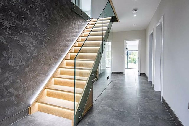 The entrance hall contains a glass balustrade with LED lighting.