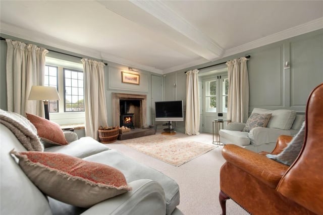 The panelled drawing room has a decorative moulded chimney piece.