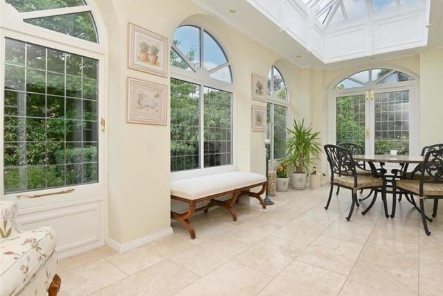 Another terrific space to relax, the orangery is bright, spacious and has double door access to the garden outside.