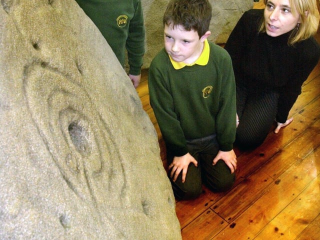Pupils Georgina Workman and Jack Malden both aged 7 years and teacher Marisa Signora   looked at the life size replicas of the Ashover Rock Art, two unique pices of Bronze Age cup and rock art discovered in the grounds of their school Ashover Primary, Ashover near Chesterfield in 2003