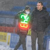 James Rowe looks on from a snowy touchline against Solihull Moors on Saturday.