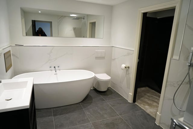Some of the modern bathrooms are fitted with televisions.