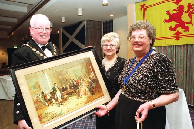 Caledonian Society of Sheffield Annual Dinner Dance in Celebration of the 242nd Anniversary of the Birth of Robert Burns at the Grosvenor House Hotel in 2001 left to right:
Society President Richard Coghill, Chief Executive of the Robert Burns World Federation Shirley Bell and Mrs Anne Coghill take a look at a painting of Robert Burns shown in Edinburgh
