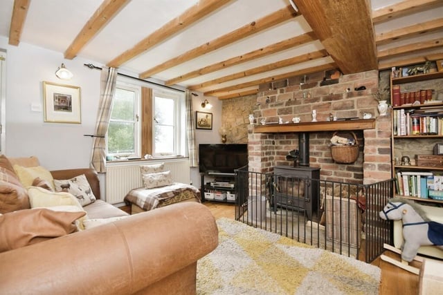 A large archway gives access from the kitchen to the lounge where a multi-fuel stove sits in a brick fireplace with a stone hearth.  The lounge has exposed stonework, a stripped wooden floor and exposed beams to the ceiling. An open staircase leads to the first floor accommodation.