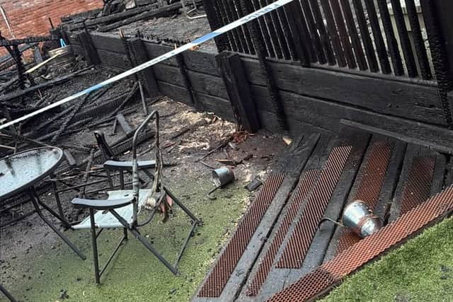 Outdoor seating area destroyed by fire.