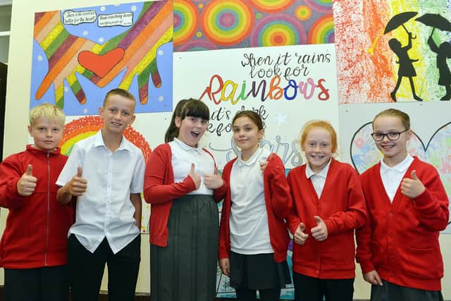 Students at Highfield Hall Primary school pictured with a lockdown murial which they helped create