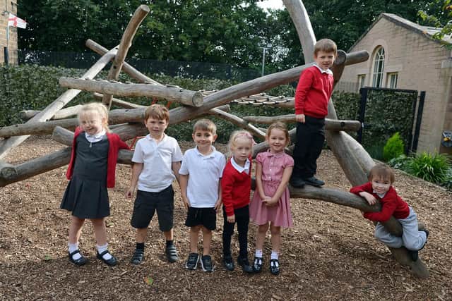 Reception class enjoying the outdoors in the earlys years outdoor activity area.