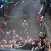 Rival teams battle for the ball in the annual Shrove Tuesday "no rules" football match.