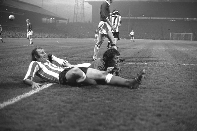 Phil Tingay he dives out to meet a challenge by Dick Malone during a match against Sunderland.
