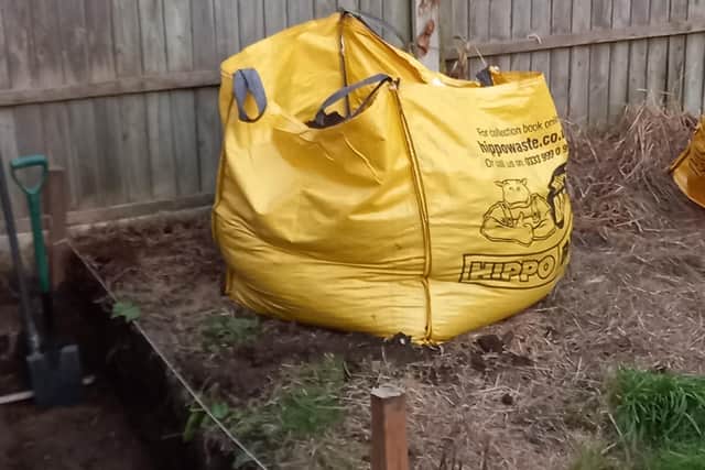 A huge waste bag of coal collected in the garden