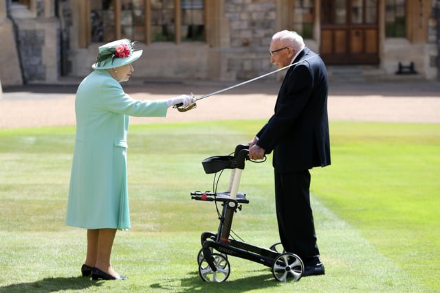 Captain Sir Thomas Moore receiving his knighthood from Queen Elizabeth II during a ceremony at Windsor Castle.