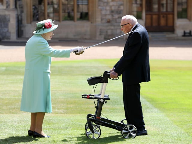 Captain Sir Thomas Moore receiving his knighthood from Queen Elizabeth II during a ceremony at Windsor Castle.