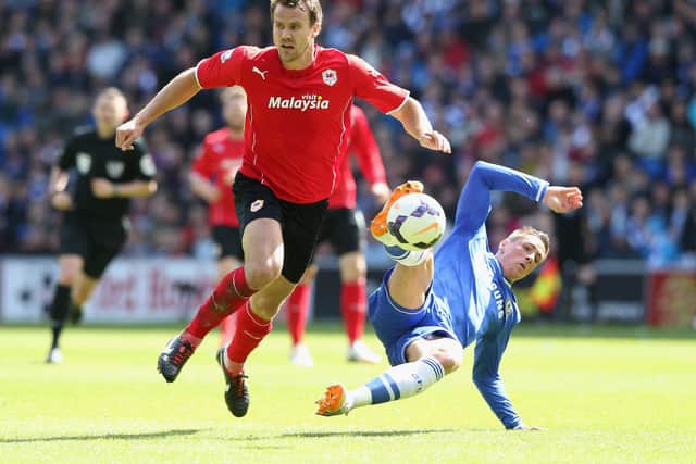 Ben Turner tussles with Chelsea's Fernando Torres during a Premier League game for Cardiff in 2014.