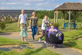 Jacob White and his family taking a walk in the hospice gardens