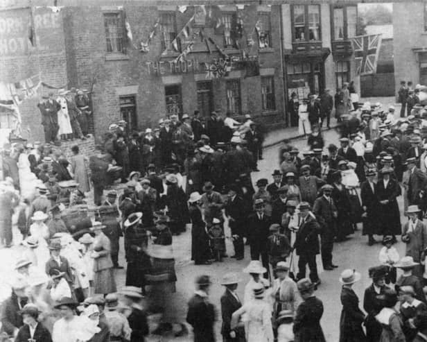 Celebrating the end of World War I in Market Place, Ripley. Pictured in the background is the Thorn Tree Public House which is still there now. Houses to the right of the photo have been demolished. The Town Hall is off to the right of the photo.