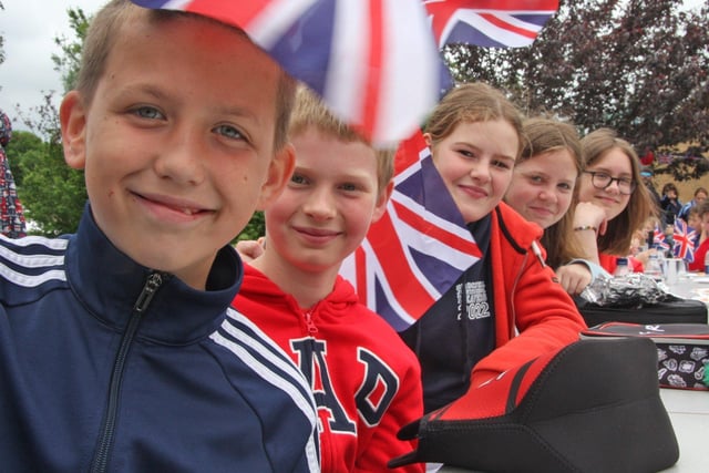 Year 6 pupils at Brockwell Juniors waving their union jack flags as part of Jubilee celebrations